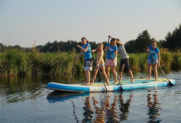 Mit dem Stand-Up-Paddel durch den Museumshafen Auf das Achter-Board ist man in einer kleinen Gruppe auf dem Wasser unterwegs.