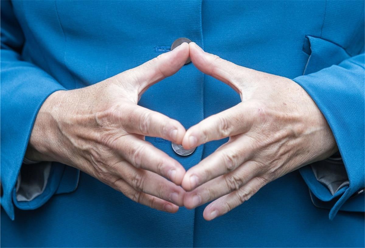 2015, Berlin: Bundeskanzlerin Angela Merkel (CDU) hat beim Bürgerfest im Garten von Schloss Bellevue in Berlin ihre Hände zu einer Raute geformt.