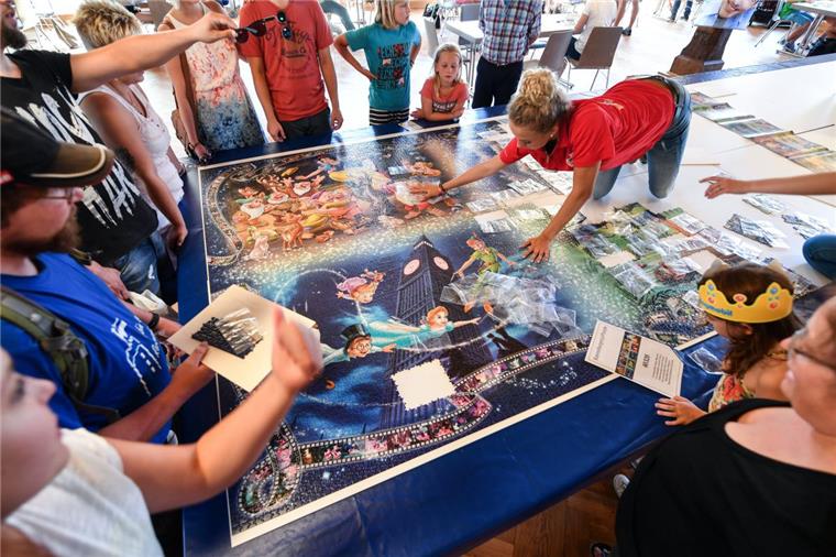 Auszubildende des Spieleherstellers Ravensburger bauen  das  nach Angaben des Unternehmens größte seriengefertigte Puzzle der Welt zusammen.  Insgesamt umfasst das Puzzler 40 320 Teile