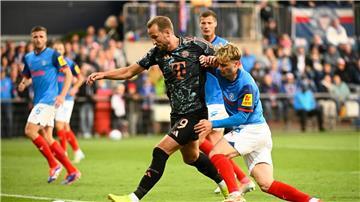 Bayerns Harry Kane (l-r) behauptet den Ball gegen Kiels Finn Porath.