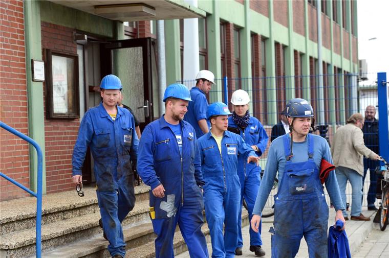 Beschäftigte der Lloyd Werft verlassen die Betriebsversammlung
am Freitagmorgen. 