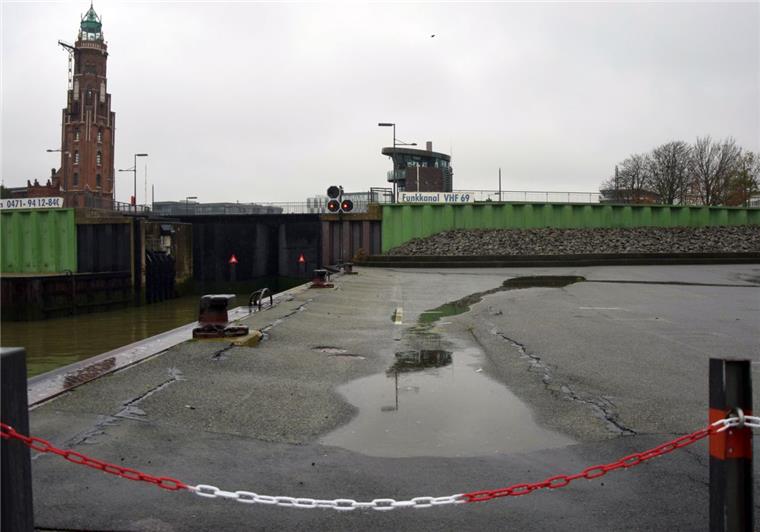 Bewegung im Untergrund lässt die Fläche hinter der Kaje an der Sportbootschleuse in Bremerhaven absacken. Der Bereich wurde abgesperrt.