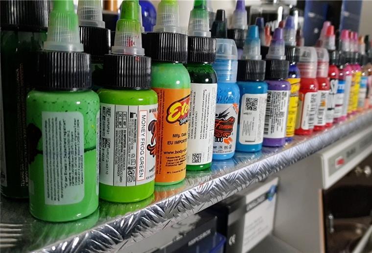 Tattoo-Farben stehen in einem Studio in einer Reihe.