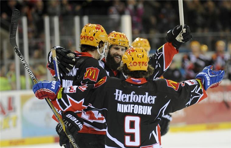 Brock Hooton (von links), Cody Lampl und Alex Nikiforuk bejubeln den Sieg der Fischtown Pinguins gegen die Wölfe Freiburg. Foto Scheschonka