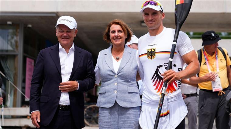 Bundesregierung reagiert auf Kritik an Sportförderung Bundeskanzler Olaf Scholz (l) und seine Frau Britta Ernst lassen sich mit Olympiasieger Tom Liebscher-Lucz fotografieren.
