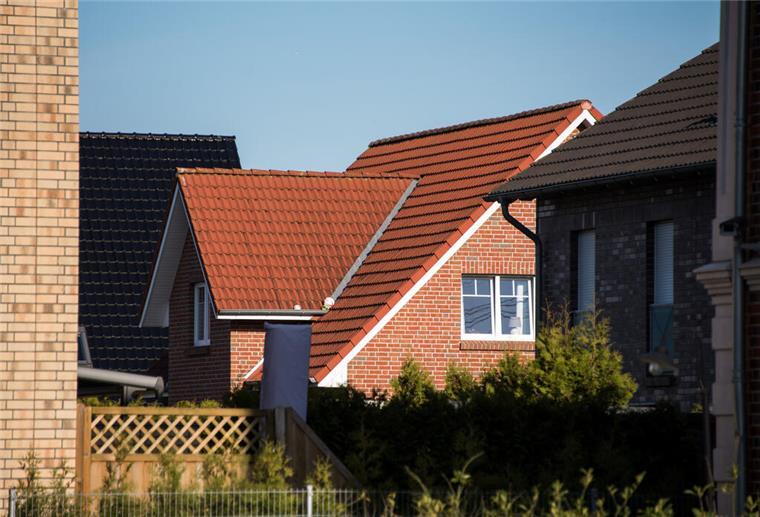 Ein Wohnhaus steht in einem Neubaugebiet. 