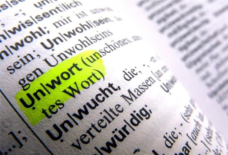 Die Seite eines Wörterbuches, das Wort Unwort ist gelb makiert. 