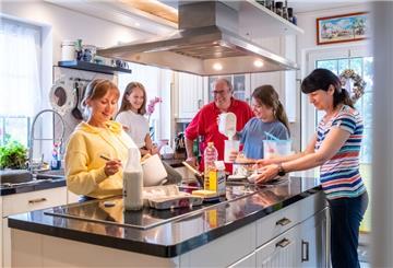 Den Alltag versüßen: Liudmyla, Kristina, Zarina und Nina bereiten mit Gastgeber Thomas Lang in der heimischen Küche in Langen einen Pfannkuchen nach ukrainischem Rezept zu.