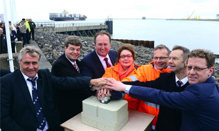 Den Startknopf für den Baubeginn des Liegeplatzes 4 im Cuxhavener Tiefwasserhafen drücken alle gemeinsam: Dr. Ulrich Getsch (von links), Enak Ferlemann,  Uwe Santjer, Daniela Behrens, Holger Banik,  Hans-Peter Zint und
Michael De Reese. Foto Scheer