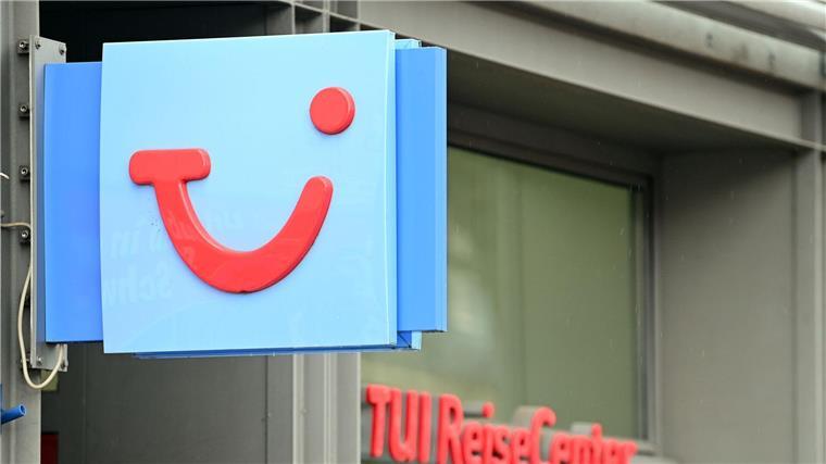 Tui will mehr verdienen: Verkündet Ende der Preissprünge Der Logo des Reiseveranstalters TUI hängt neben der Tür zu einem TUI ReiseCenter.