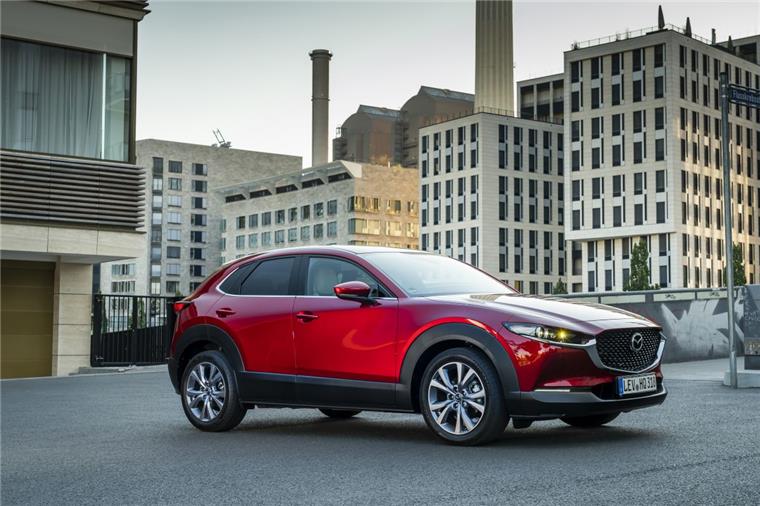 Roter Mazda CX-30 steht in einer Großstadt