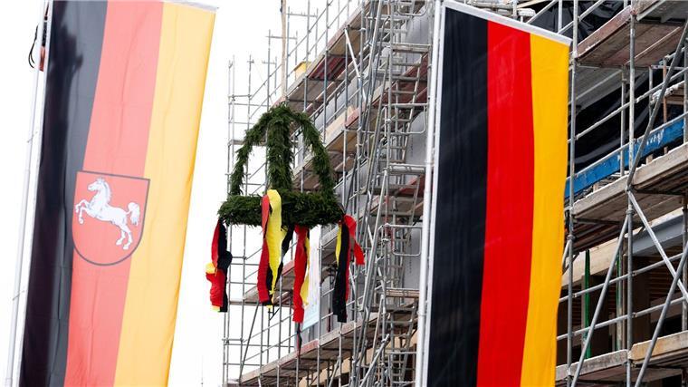 Richtfest bei neuem Besucherzentrum des Museums Friedland Der Richtkranz ist beim Richtfest für das Museum Friedland hinter Flaggen zu sehen.
