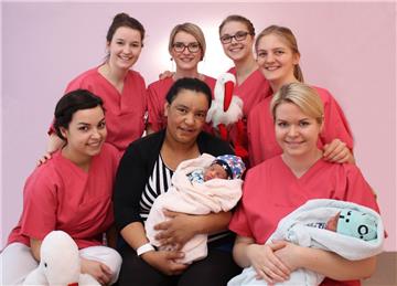 Die Auszubildenden der Hebammenhilfe (von links): Madline Almeida-Marques, Nina Bürvenich, Edera Litau, Larissa Herbst, Katharina Thoden und Karen Allers mit Mutter Moumine Achmet (Mitte) und ihren Babys Bernan und Berkay. 
