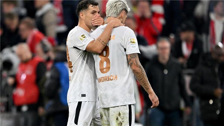 Defensive Leverkusener zufrieden: „Nicht immer Tiki-Taka“ Die Bayer-Profis Granit Xhaka (links) und Robert Andrich sind zufrieden über das 1:1 in München.