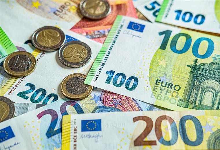 Münzen und Geldscheine liegen auf einem Tisch. Die Bundesregierung plant, Zuschläge für Überstunden steuerfrei zu stellen. Das könnte Arbeitnehmern mehrere Hundert Euro im Jahr extra bringen.