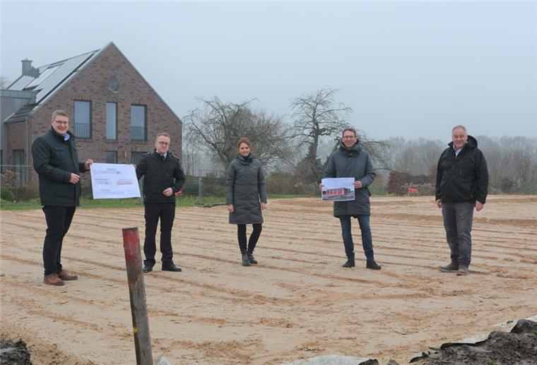 Eine Gruppe von Menschen steht auf einer Baustelle.