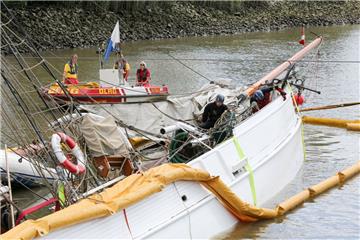 DLRG-Mitarbeiter und Taucher eines Hamburger Unternehmens sind auf dem gesunkenen historischen Segelschiff "No 5 Elbe" im Hafen von Stadersand im Einsatz. Das historische Segelschiff war auf der Elbe mit einem Containerschiff kollidiert und gesunken.