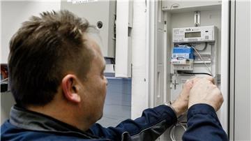 Ein Elektriker montiert einen digitalen Stromzähler mit einem Smart-Meter-Gateway zur Datenübertragung.