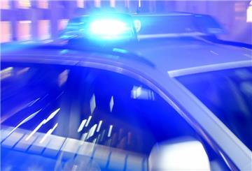  Ein Streifenwagen der Bundespolizei steht mit eingeschaltetem Blaulicht in der Ausfahrt einer Garage. 