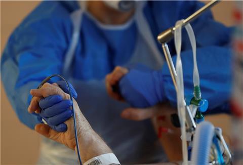 Ein Krankenhausmitarbeiter betreut einen Coronavirus-Patienten auf der Intensivstation des Universitätskrankenhauses.