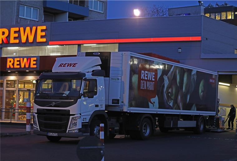 Trotz Hamsterkäufen - Supermärkte geben Entwarnung Ein Lkw steht am frühen Morgen vor einem Rewe-Supermarkt, der mit Waren beliefert wird.