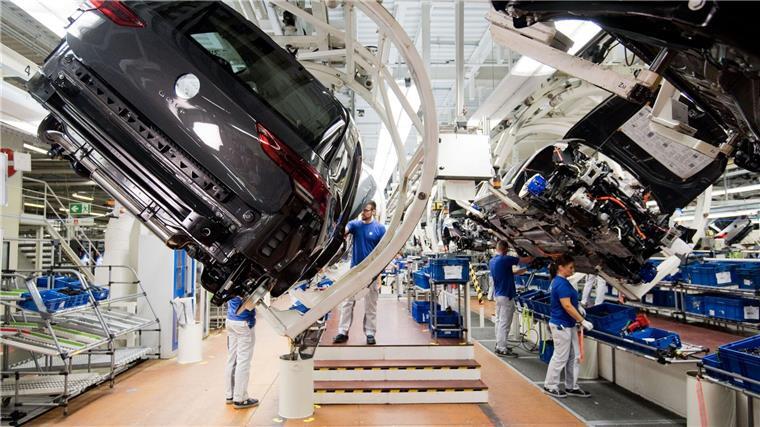 VW will Bachelor-Absolventen in Produktion einsetzen Ein neuer Volkswagen Golf 8 (l) schwebt an einer Produktionslinie im VW Werk.