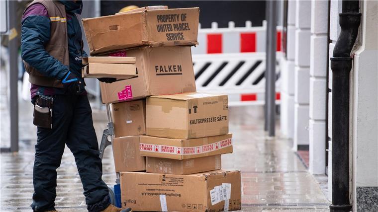 Ein Paketbote liefert Pakete aus.