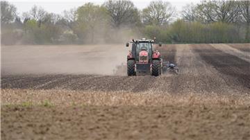 Ein Traktor fährt über einen Acker.
