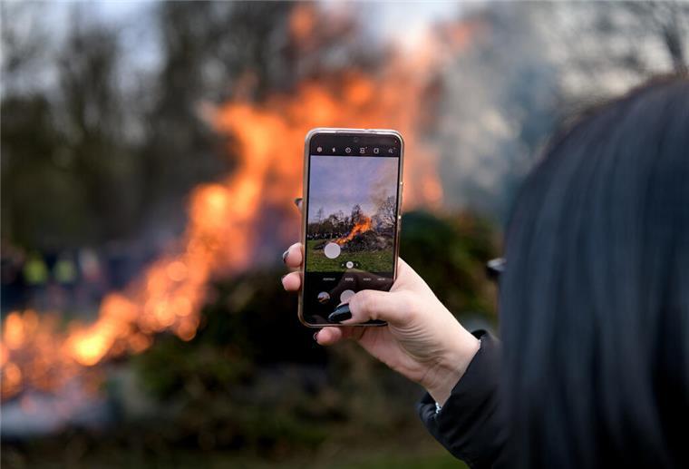 Keine Randale: Polizei zieht positives Fazit nach Osterfeuern im Cuxland Eine Besucherin filmt ein Osterfeuer - so friedlich verhielten sich offenbar alle.
