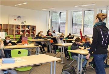 Eine Grundschulklasse mit ihrer Lehrerin beim Unterricht: Ob das Schuljahr aufgrund der Corona-Pandemie wiederholt werden sollte, darüber gehen die Meinungen im Kreiselternrat auseinander. 