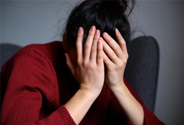 Arbeitswelt: Der Stress nimmt immer mehr zu Eine Frau sitzt mit dem Kopf in den Händen auf einem Stuhl.