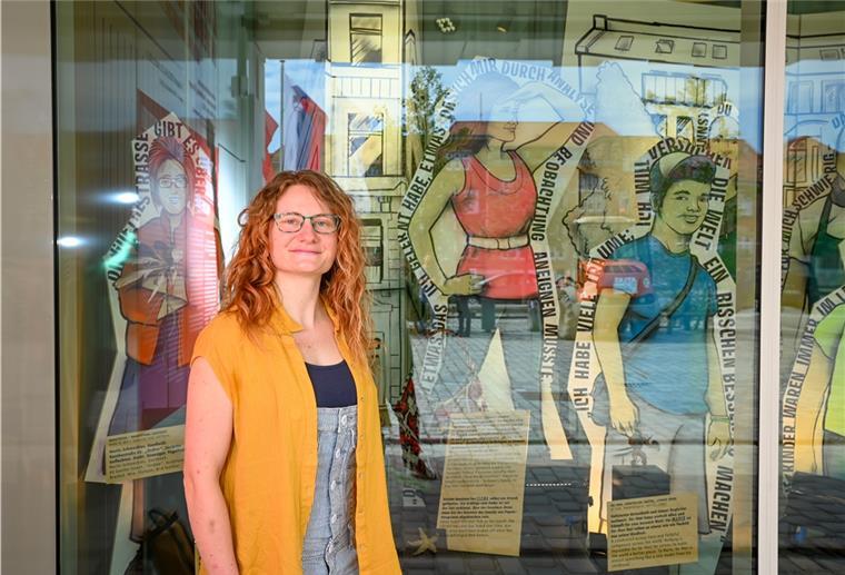 Elena Schiller steht vor ihrer Pappfigur im roten Shirt, die in die Ferne. Sie ist eine der Potagonistinnen in der Garagen-Ausstellung im Deutschen Auswandererhaus. 