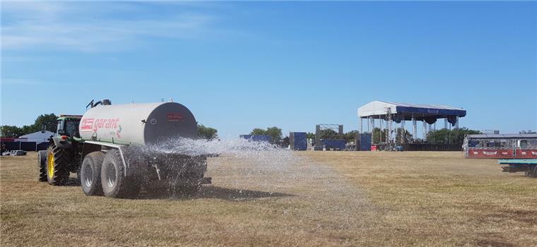 Brandgefahr auf dem Deichbrand: Helfer in Alarmbereitschaft Gegen die Brandgefahr: Nicht nur die Parkflächen, auch das Infield des Deichbrand-Festivals in Wanhöden wird in der Aufbauphase gewässert.