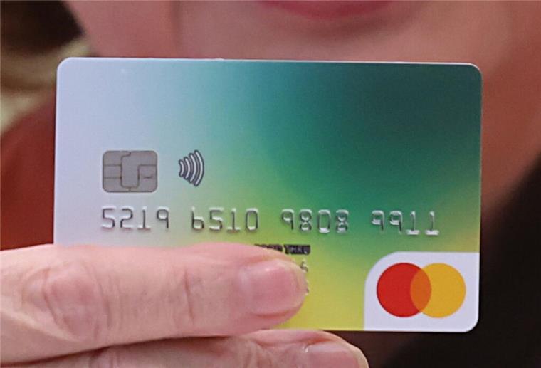 Auch Bremen macht jetzt mit: Bezahlkarte für Asylbewerber Hand hält eine Bezahlkarte