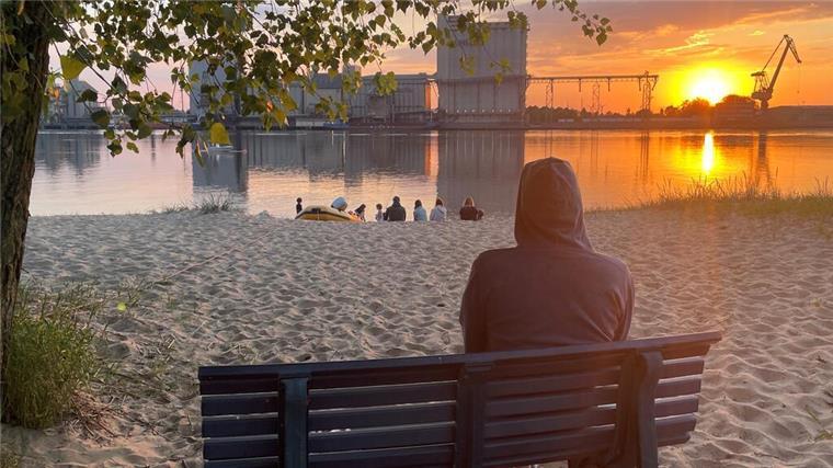 Urlaubs-Geheimtipp! So entspannt lebt es sich auf Harriersand Eine Person beobachtet den Sonnenuntergang auf Harriersand. Wir zeigen, warum sich ein Besuch auf der Insel lohnt.
