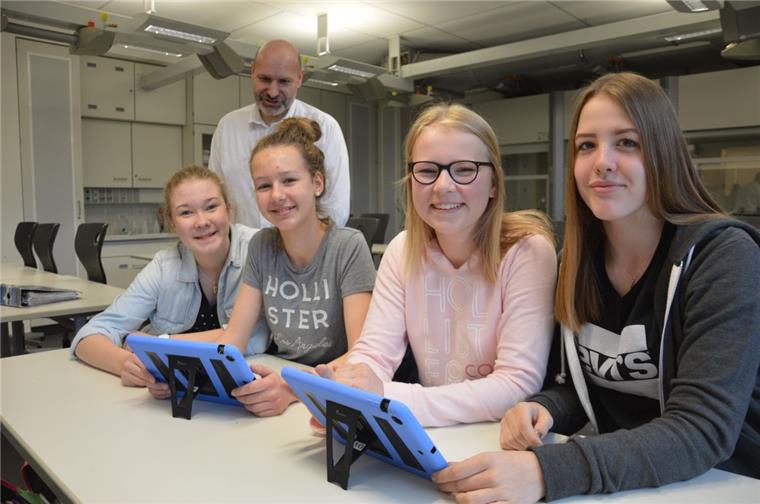 Tablets bei der Schulklausur: Wichtige Helfer oder universelle Spickzettel? Im Niedersächsischen Internatsgymnasium in Bad Bederkesa sind Tablets ein selbstverständlicher Bestandteil vieler Unterrichtsfächer, zeigen (von links) Lea Kattau, Luisa Habenicht, Juline Grimm und Nele Rümper und im Hintergrund Chemielehrer Dr. Thomas Appel. Doch in Prüfungen hat man sie bislang noch nicht eingesetzt. Ein neuer Erlass des Niedersächsischen Kultusministeriums räumt diese Möglichkeit jetzt ein.