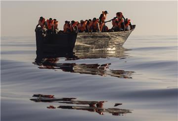Migranten mit Schwimmwesten, die von Freiwilligen des Rettungsschiffs Ocean Viking zur Verfügung gestellt wurden, segeln in einem Holzboot, während einer Rettungsaktion im Mittelmeer. 