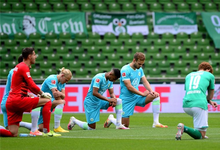 Bundesliga-Profis knien: Aktion gegen Rassismus Im Weserstadion: Spieler aus Bremen und Wolfsburg knien gemeinsam auf dem Rasen am Mittelkreis, um ein Zeichen gegen Rassismus zu setzen.
