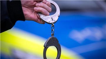 Ein Polizist hält während einer Verkehrskontrolle ein Paar Handschellen.