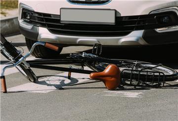 close up view of broken bicycle and car on road, car accident concept