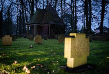Ein altes Gebäude und Grabsteine auf einem Friedhof.