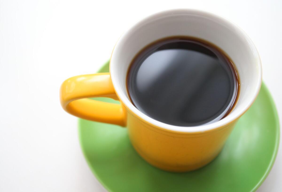 Weil Kaffee so teuer ist: Supermärkte führen neue Regel ein Symbolbild für Weil Kaffee so teuer ist: Eine gelbe Tasse mit schwarzem Kaffee steht auf einem Tisch.