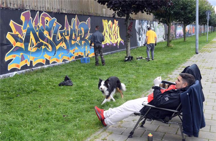 Bremerhaven: Graffiti-Künstler sprayen die Schiffbauhalle an Sehr bunt: Mal ein Päuschen und ein Blick aus der Distanz aufs Kunstwerk: 50 Graffiti-Künstler haben die ehemalige SSW-Schiffbauhalle in ein buntes Farbenmeer verwandelt.