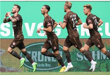 Fußballspieler des FC St. Pauli laufen auf dem Platz.