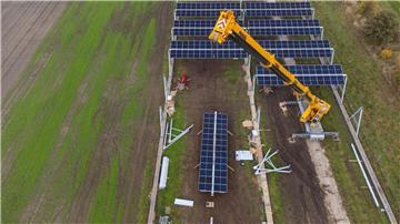 Mit einem Kran wird in Lüchow eine Agrar-Photovoltaik-Anlage montiert.