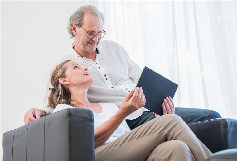 Ein Ehepaar blickt gemeinsam auf ein Tablet
