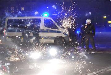Polizeibeamte stehen hinter explodierendem Feuerwerk.