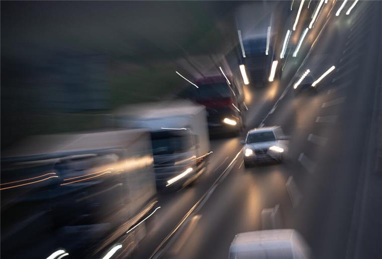 Das Bild zeigt Autos, die auf einer Straße fahren. Sie sind unscharf. 