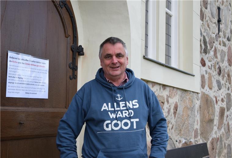 Kirche geht neue Wege in der Corona-Krise Pastor Manfred Thoden vor der geschlossenen Kirchentür in Selsingen. Trotzdem trägt er ganz bewusst den Hoodie mit dem plattdeutschen Spruch „Allens ward Goot“ - alles wird gut.