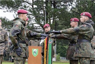 Rekruten geloben an der Truppenfahne, die Bundesrepublik Deutschland tapfer zu verteidigen.